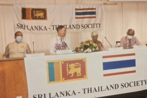 The head table at a Society meeting beneath the Sri Lankan and Thai flags