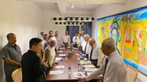 Members and guests gathered around the table at a Society meeting
