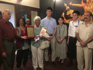 Society members presenting a commemorative plaque to a guest at a gathering