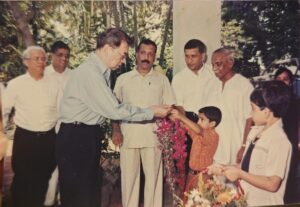 Archive photograph of a welcome ceremony with garlands being presented